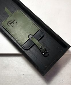 groene leren bagagelabel met zwart stiksel en gunmetal gespje